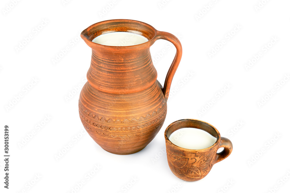 Clay jug and mug with milk isolated on white background.