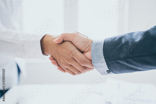 Teamwork,partnership and Social connection in business join hand together,Finishing up a meeting,handshake of happy business people after contract agreement to become a partner,collaborative teamwork. photo