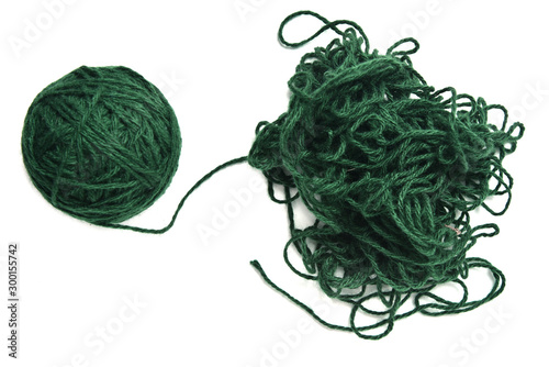 Ball of green fine wool ball thread and tangled thread on white background