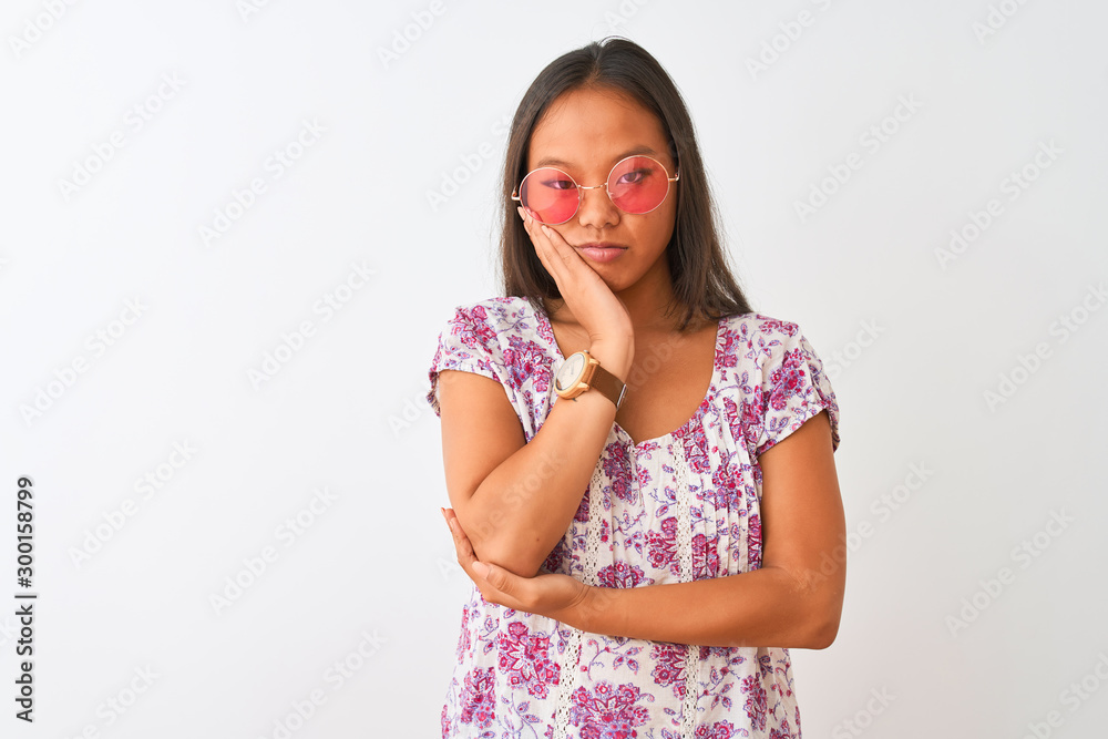 Young chinese woman wearing floral t-shirt and pink glasses over isolated white background thinking looking tired and bored with depression problems with crossed arms. Young chinese woman wearing floral t-shirt and pink glasses over isolated white background thinking looking tired and bored with depression problems with crossed arms.