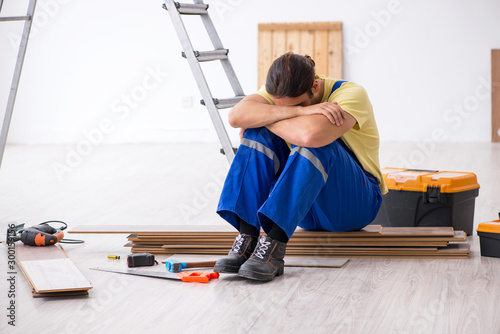 Young male contractor working indoors