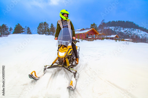 Riding a snowmobile. Girl r...