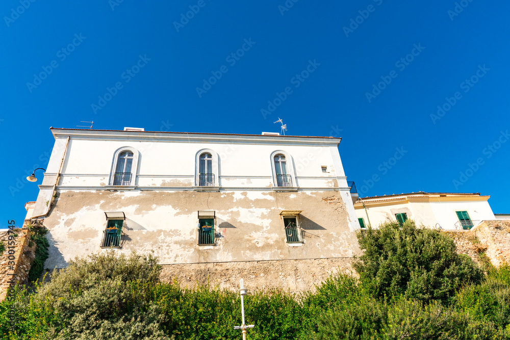 Old white building and city wall in  Termoli, Italy