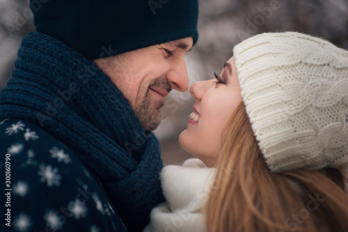 Young lovers couple hug each other dr winter walk in the park