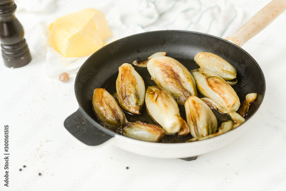 Braised chicory on the belgian way in a baking pan Braised chicory on the belgian way in a baking pan