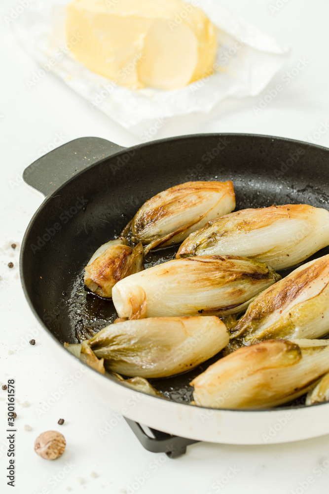 Braised chicory on the belgian way in a baking pan Braised chicory on the belgian way in a baking pan