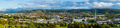 Germany, XXL panorama of scenic aerial view above roofs, houses, buildings and church of schorndorf city in warm sunset light