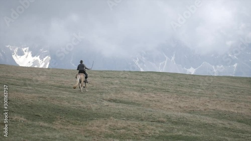 Man riding a hrose in the dolomites in slow motion. photo