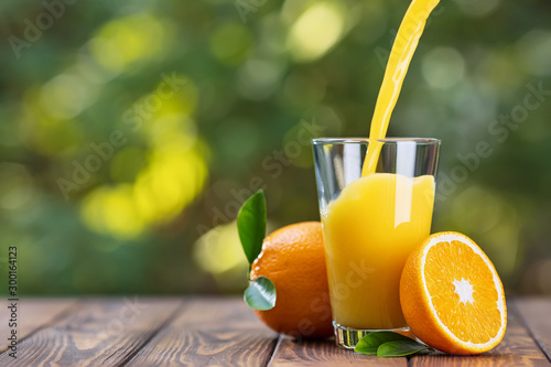 orange juice pouring in glass