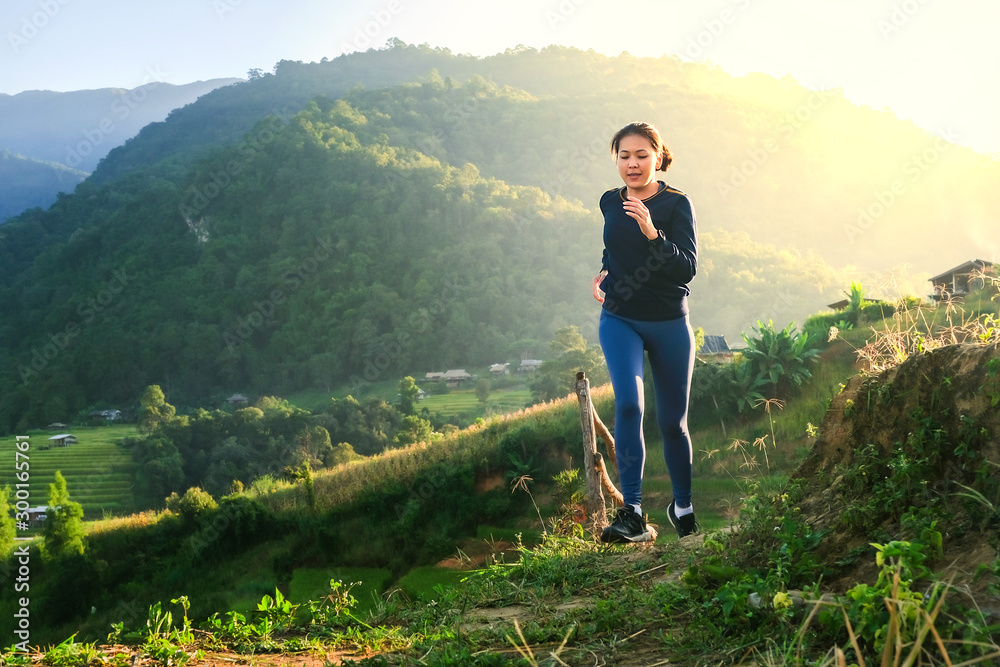 Young women run and run in the fields with mountains and sunsets. Young women run and run in the fields with mountains and sunsets.