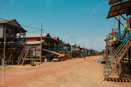 Floating village Residential houses on wooden poles and red soil road in Kampong Phluk Cambodia near Tonle Sap Lake