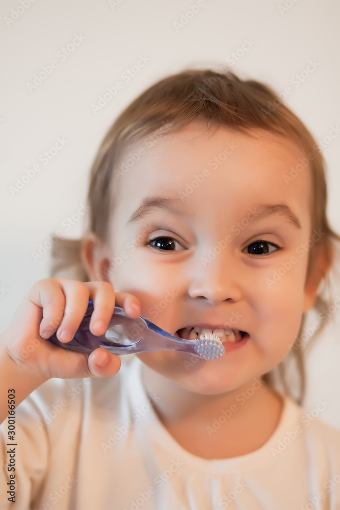Little cute girl smailing and brushing her teeth. Little cute girl smailing and brushing her teeth.