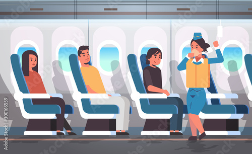 stewardess explaining safety instructions with life vest for passengers flight attendant demonstrating how to use oxygen mask in emergency situation modern airplane board interior horizontal vector