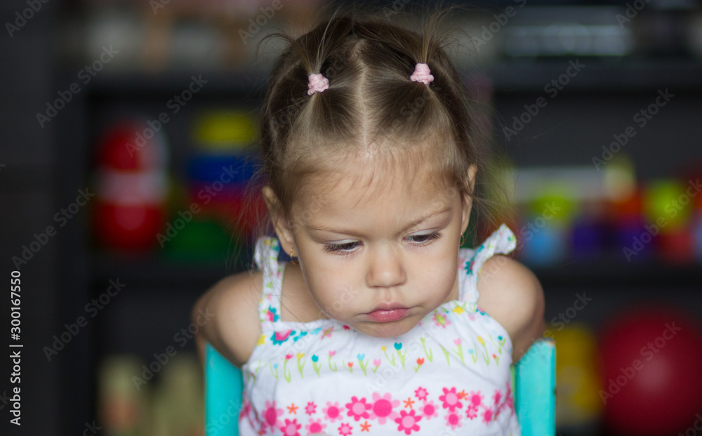 Portrait of sad and tired little girl looking down Portrait of sad and tired little girl looking down