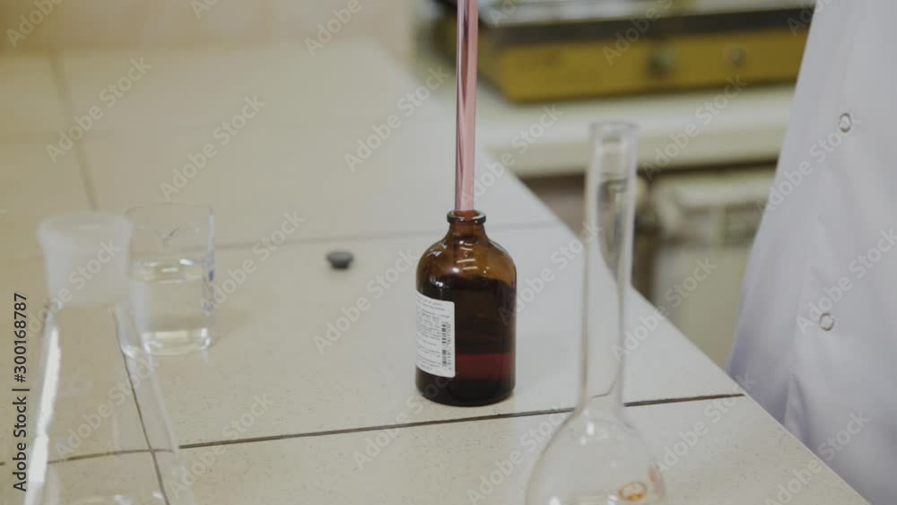 Male scientist with test tubes in a laboratory conducts an experiment. Male scientist with test tubes in a laboratory conducts an experiment.