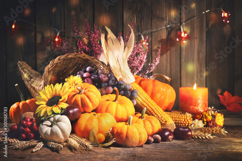 Konstfotografi Pumpkins with fruits and falling leaves on rustic wooden table