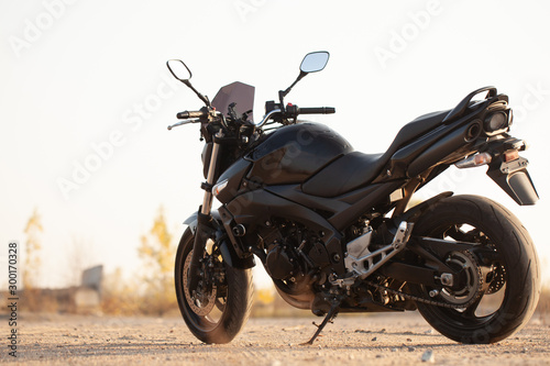 One black motorcycle in the desert. photo