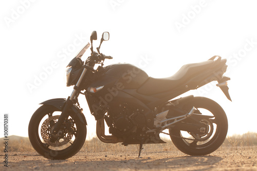 One black motorcycle in the desert. photo