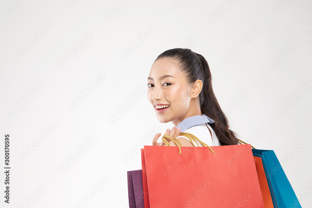 Shopping Asian woman smile and Holding Shopping bags,Cheerful and happiness emotional,Enjoy Shopping in black friday sale,Isolated on gray background,Shopping Concept Shopping Asian woman smile and Holding Shopping bags,Cheerful and happiness emotional,Enjoy Shopping in black friday sale,Isolated on gray background,Shopping Concept