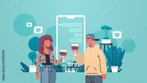 Man woman drinking wine couple using mobile