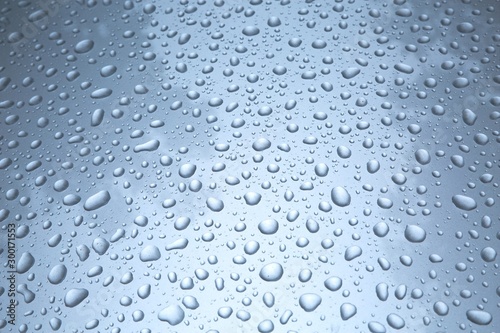 Water drops on a shiny paint surface of a car