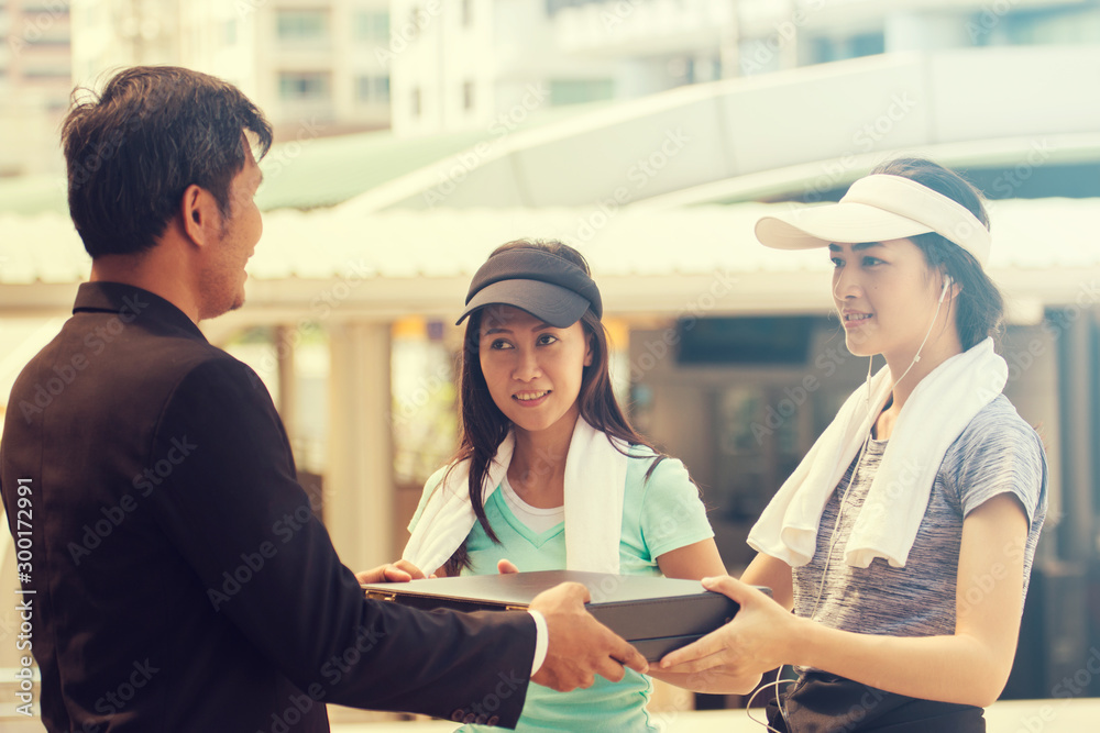 Businessman give something to women exercise Businessman give something to women exercise
