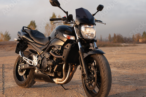 One black motorcycle in the desert.