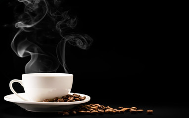Foto auf Leinwand Küche Cup coffee with steam and beans on a black background, a place for text.  © innafoto2017