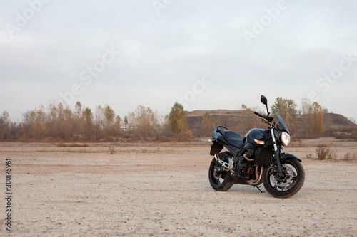 One black motorcycle in the desert.