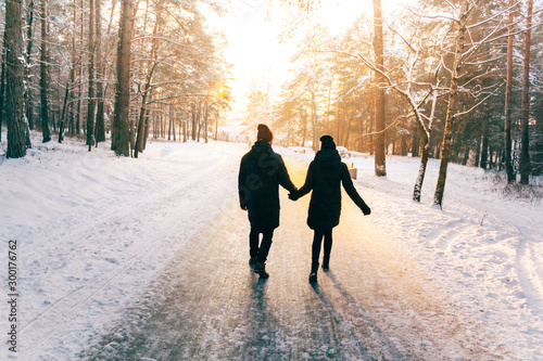 Couple Holding Hands Walking Away. Winter, Sunny, Forrest, Recreation, Leisure, Clothing.