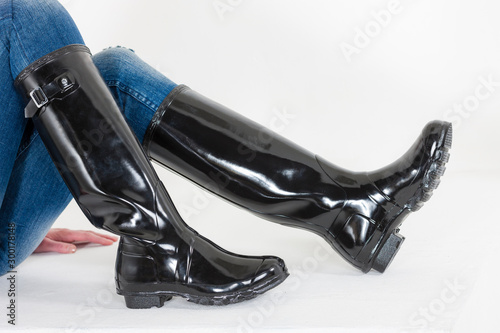 women's black rubber boots with blue jeans photo