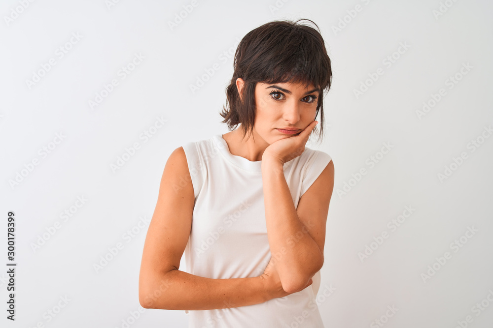 Young beautiful woman wearing casual t-shirt standing over isolated white background thinking looking tired and bored with depression problems with crossed arms. Young beautiful woman wearing casual t-shirt standing over isolated white background thinking looking tired and bored with depression problems with crossed arms.