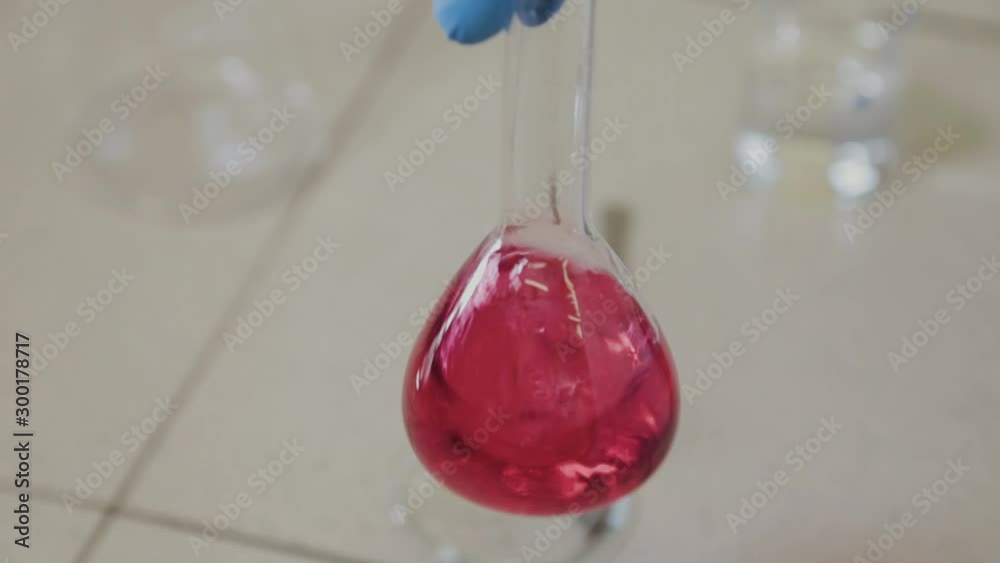 Male scientist with test tubes in a laboratory conducts an experiment. Male scientist with test tubes in a laboratory conducts an experiment.