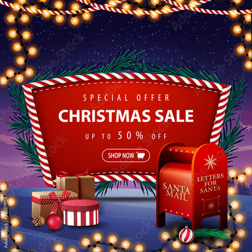 Special offer, Christmas sale, up to 50% off, red discount banner with Christmas tree branches, garland, winter landscape on the background and Santa letterbox with presents