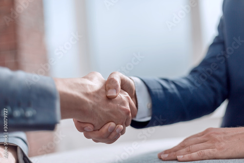 close up. successful financial partners shaking hands.