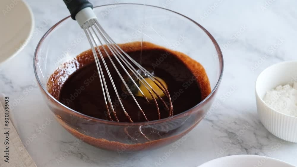 Chef hands breaking egg. Egg break in slow motion. Making homemade chocolate cake. Baking ingredients Chef hands breaking egg. Egg break in slow motion. Making homemade chocolate cake. Baking ingredients
