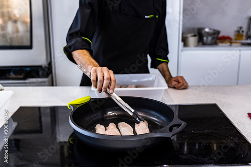 Chef frying a bass on a restaurant