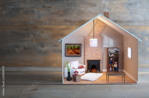 Miniature house over a wooden background photo