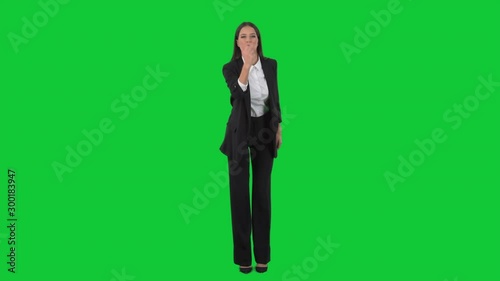 Angry young business woman director showing obscene middle finger gesture at camera. Full length on green screen background. 
