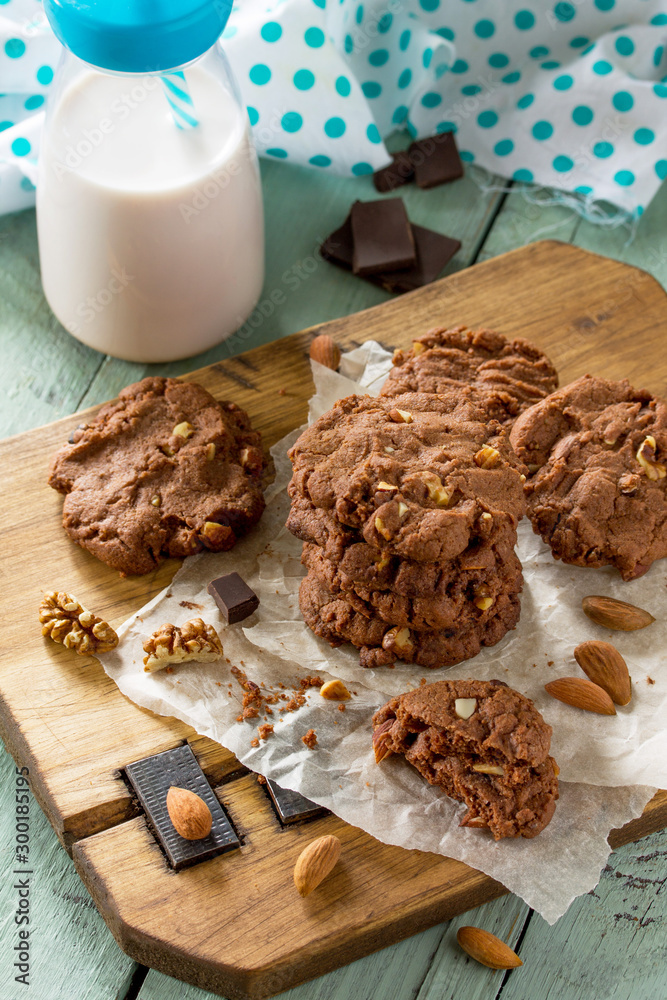 Fototapeta premium Baked christmas cookies. Homemade Chocolate chip cookies and milk on a wooden rustic table.