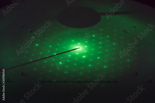 Crystallographic structure of tremolite fibers (asbestos variety) seen (diffracted light) on the fluorescent screen of a Transmission Electron Microscope (TEM)