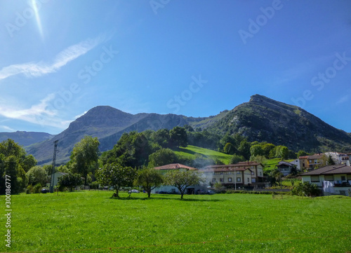 Cantabria landscape with field, montains, river and a small village. Spain