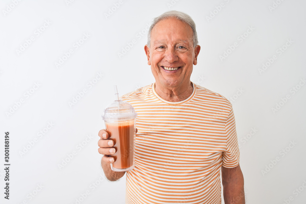 Senior man wearing striped t-shirt drinking tomato smoothie over isolated white background with a happy face standing and smiling with a confident smile showing teeth Senior man wearing striped t-shirt drinking tomato smoothie over isolated white background with a happy face standing and smiling with a confident smile showing teeth
