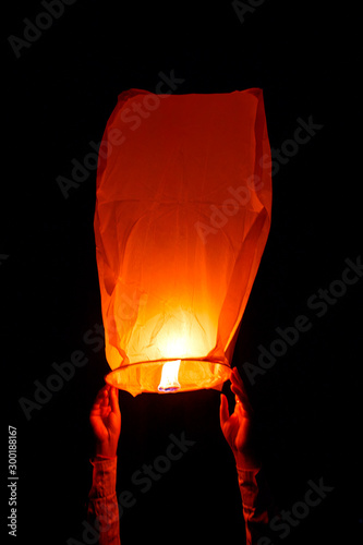 sky lantern, also known as Kongming lantern or Chinese lantern in black sky photo