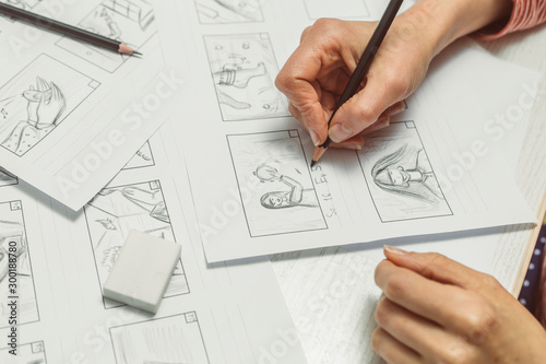 Woman's hand draws a storyboard for a film or cartoon.