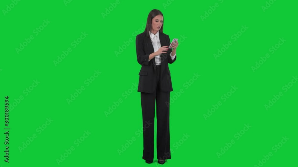 Worried young unhappy woman reading bad news on mobile smart phone. Full length on green screen background. 