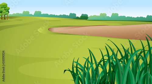 Scene with green grass and sand pit