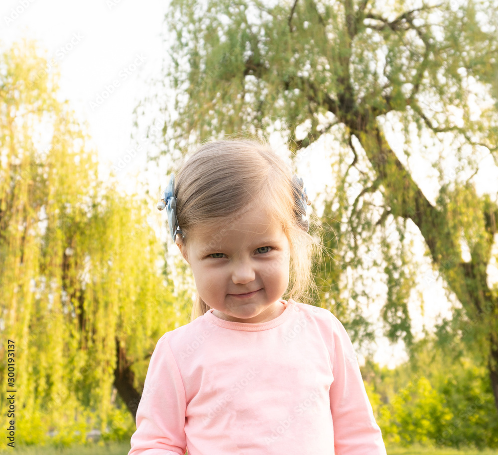 Funny cute little girl with angry face looking in camera Funny cute little girl with angry face looking in camera