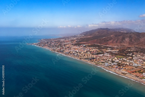 Aerial view from a plane of the coast of Torremolinos, Benalmadena and Fuengirola and Costa del Sol, Malaga in Spain. Real estate developement concept photo