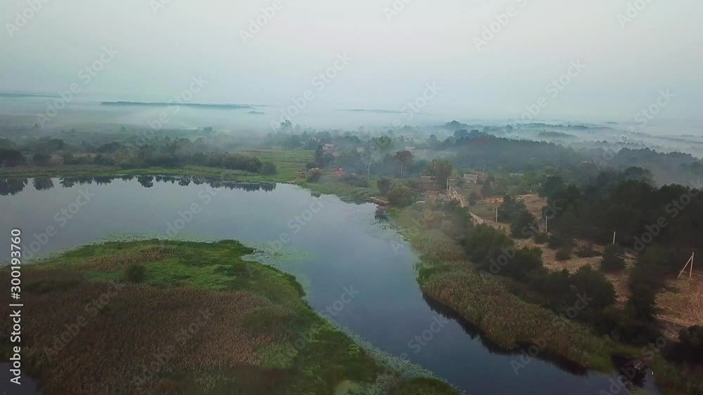aerial view of village by the lake in the morning mist, aerial view of lake at sunrise, fog and sun over rivers, aerial view of fog over the marsh at dawn aerial view of village by the lake in the morning mist, aerial view of lake at sunrise, fog and sun over rivers, aerial view of fog over the marsh at dawn